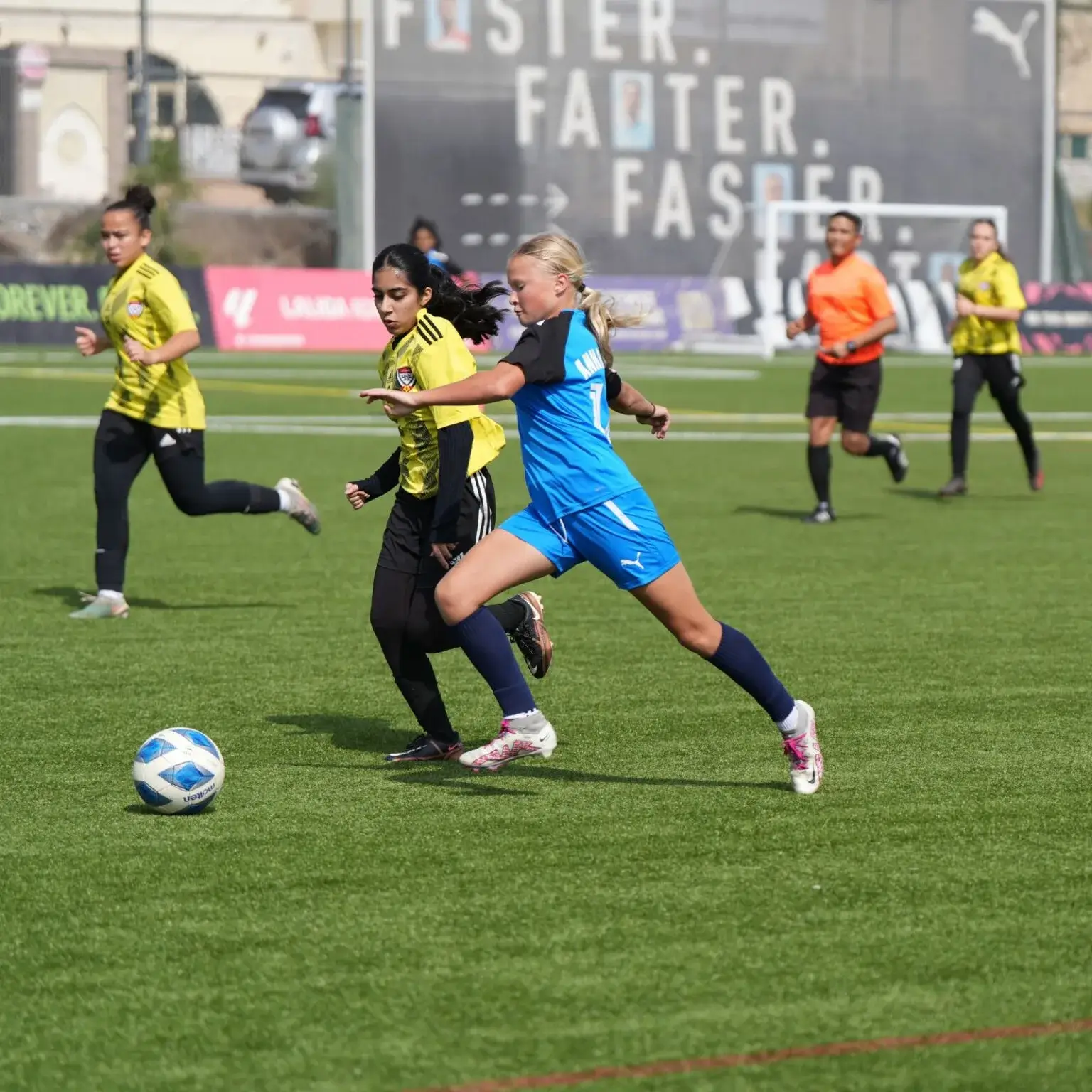 DOFA Season 2023 | A diverse group of girls playing football on a field.