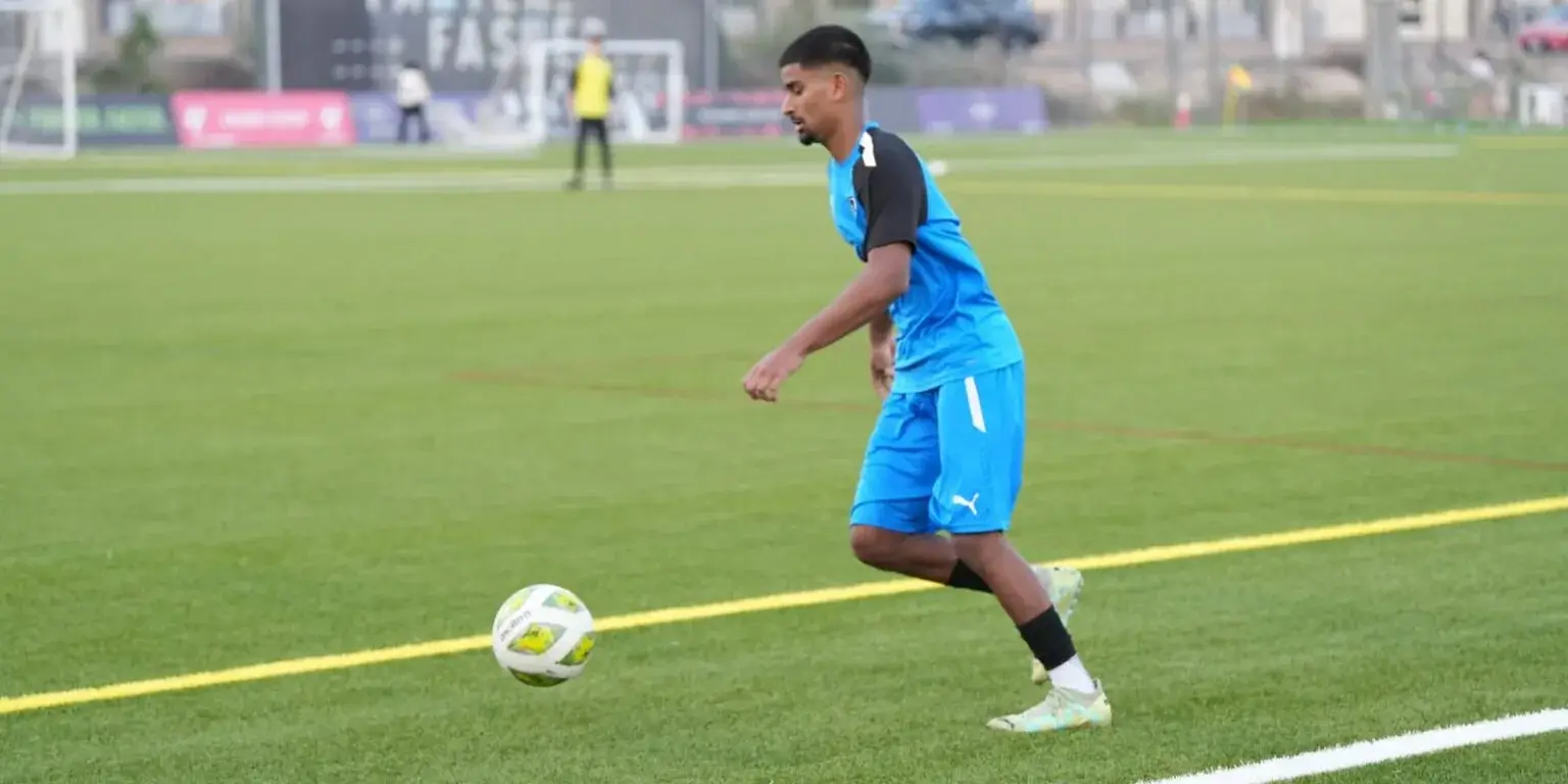 DOFA Season 2023 | A football player in a blue uniform kicking a ball on a green field