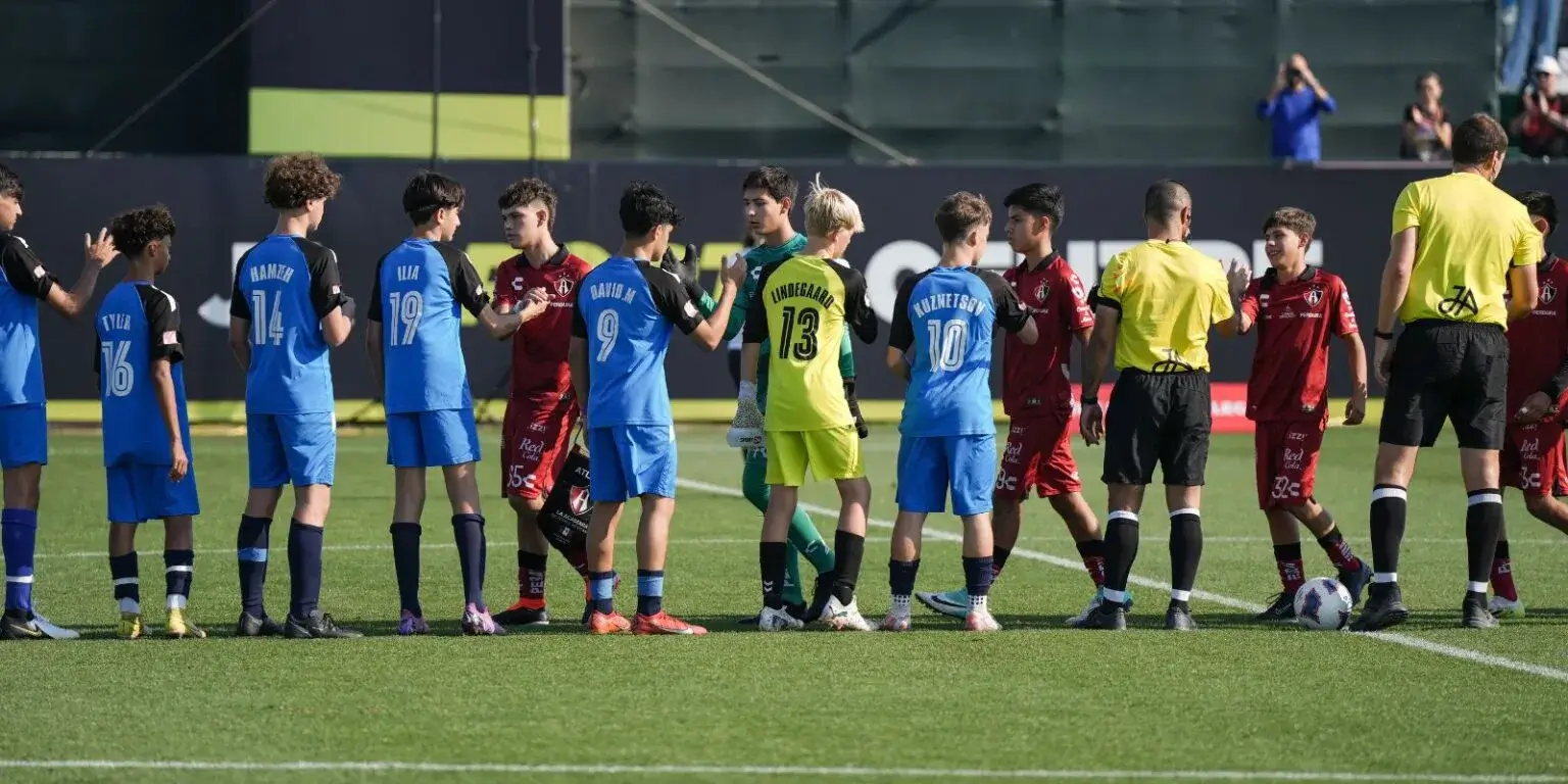 Group of young male football players gathered on the field | Mina Cup 2024.