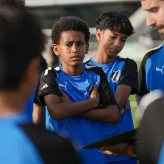 LaLiga Academy UAE | Players in LaLiga Academy Dubai listening to instructions from their football coach