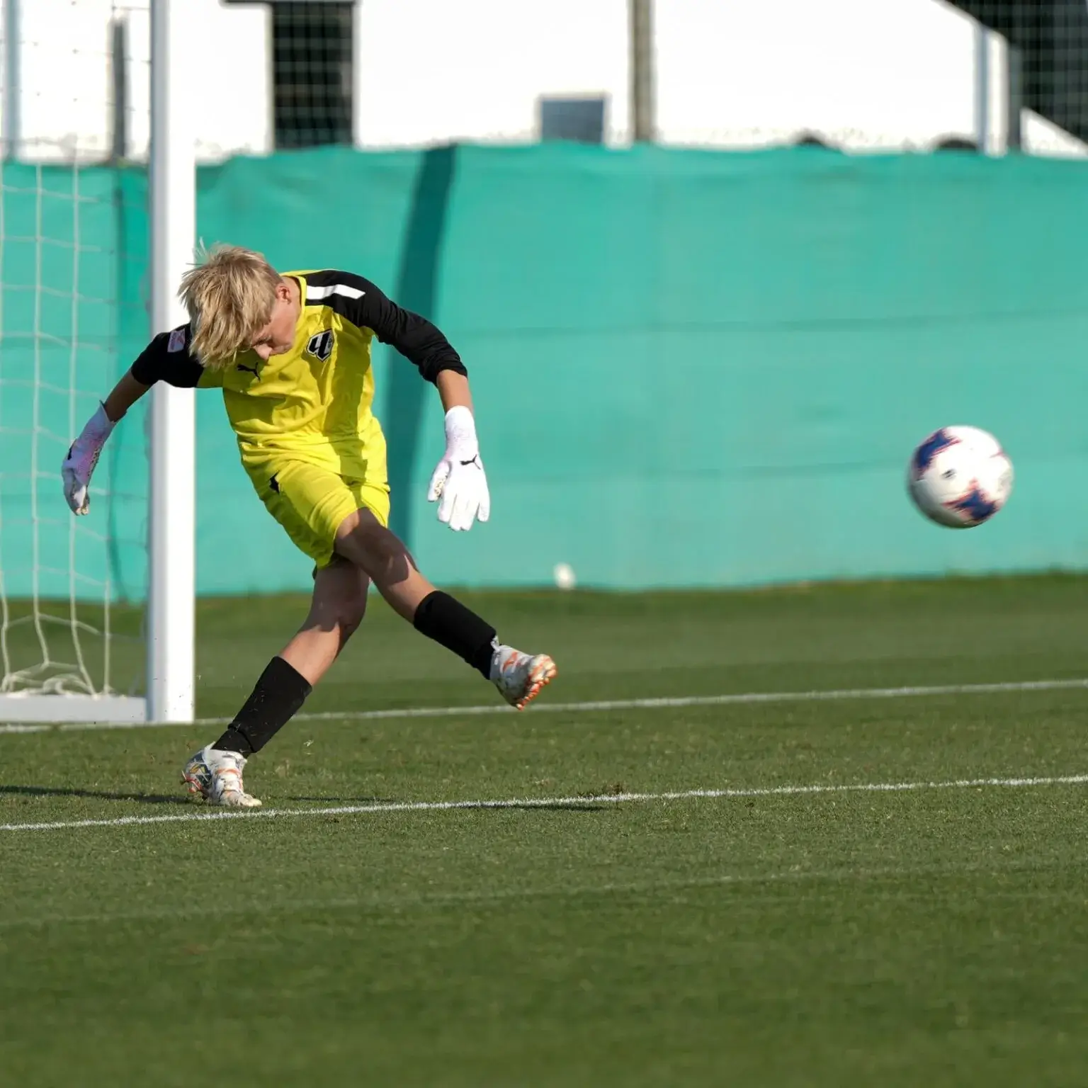 Soccer player preparing to kick ball on field | Mina Cup 2024.