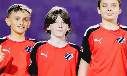 Three Young Boys in Red and Black Soccer Uniforms | Football Classes Near Me