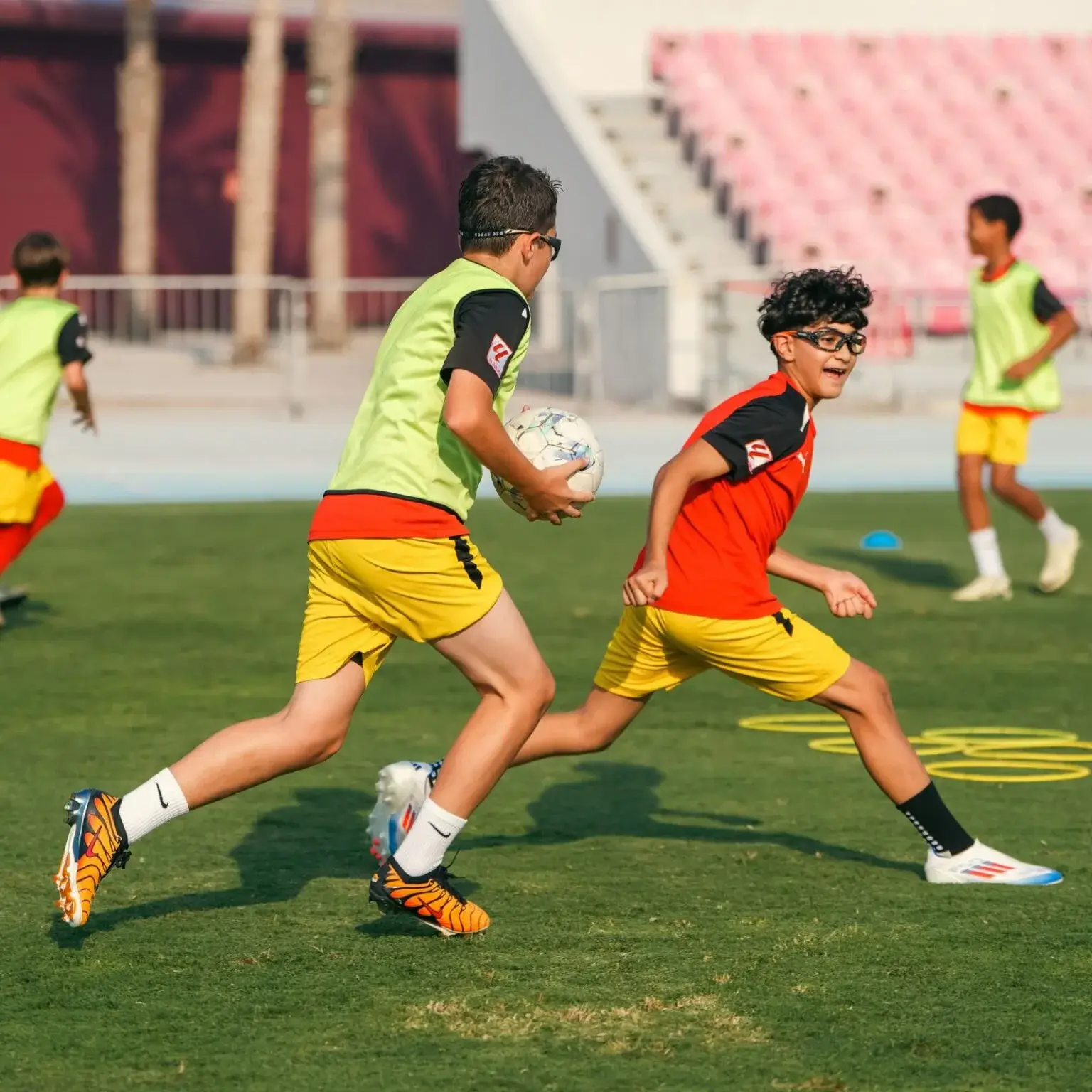 Two boys playing football on a field during last training session before IBER Cup.