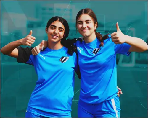 Two Girls in Blue Soccer Uniforms Giving Thumbs Up | Girls Soccer Academy