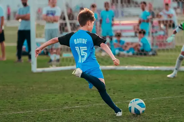 Young Boy Practicing Soccer Skills During Football Coaching in Dubai