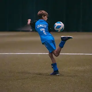 Young player practicing soccer skills at LaLiga Academy Dubai's Open Trials.