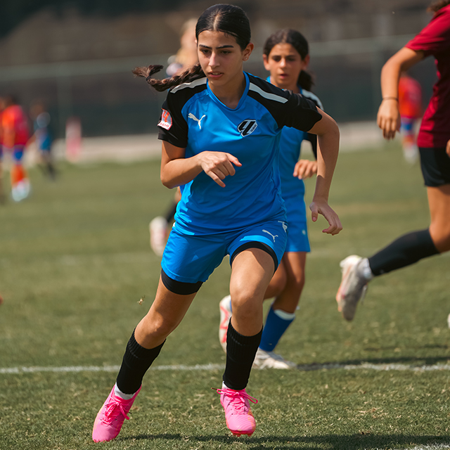 A girl learning to play football at LaLiga Academy Dubai