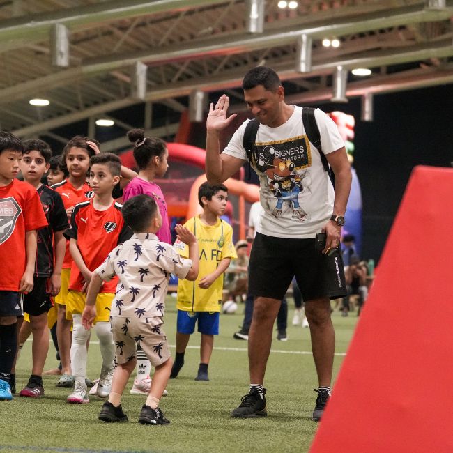 A parent of a player in LaLiga Academy Dubai celebrating with his child