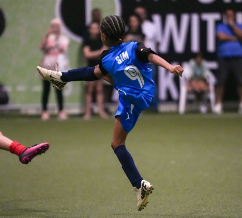 A young boy showing great football skills during a match at LaLiga Academy Dubai