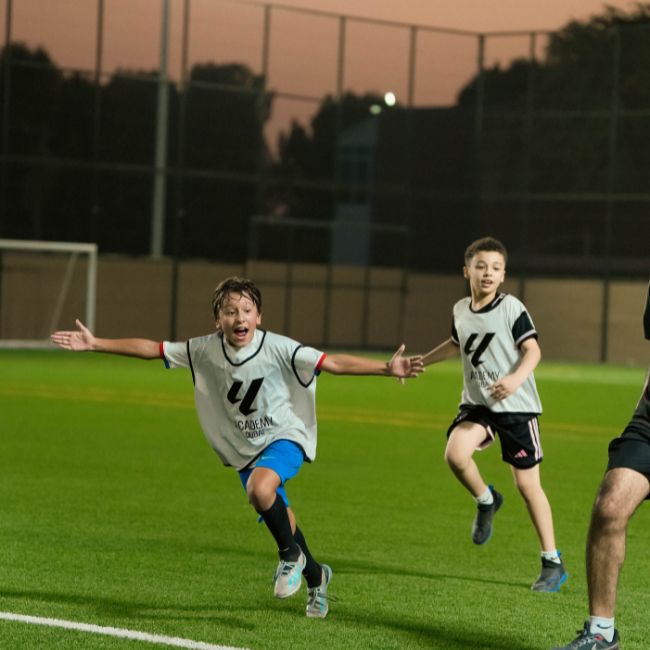 Young football players celebrating a goal at LaLiga Academy Dubai's new location in Police Academy Park in Al Sufouh