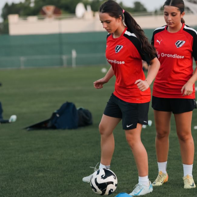 A young girl at LaLiga Academy Dubai taking part in football drill at LaLiga Academy in Dubai Sports City