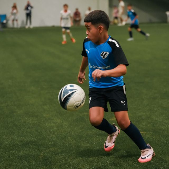 An U10 boy of LaLiga Academy Dubai's Advanced Squad during a match in DOFA league at ISD Dubai Sports City upgraded full size indoor football pitch