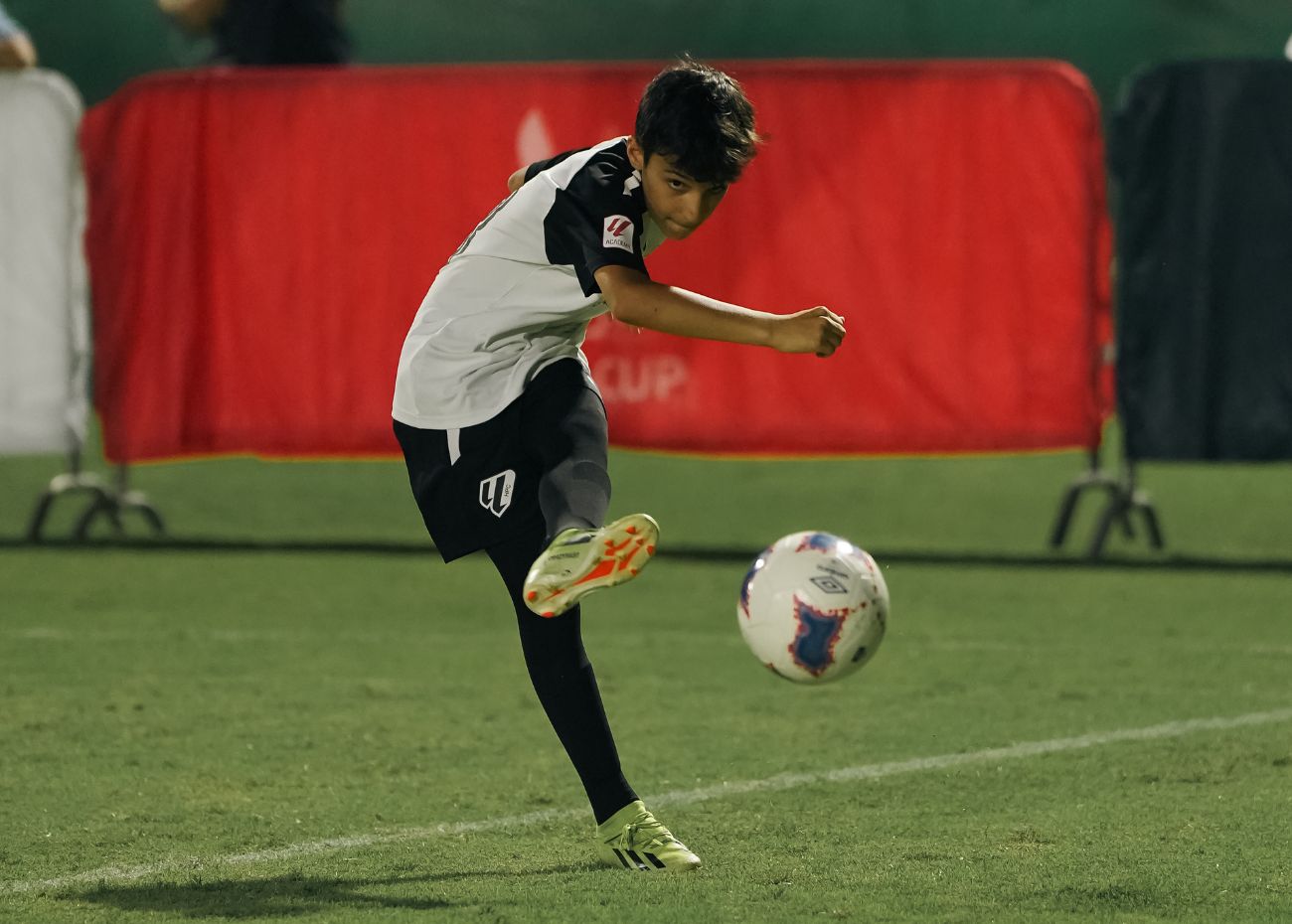 A young boy who plays for LaLiga Academy Dubai during a match in the MINA Cup in Dubai Sports City