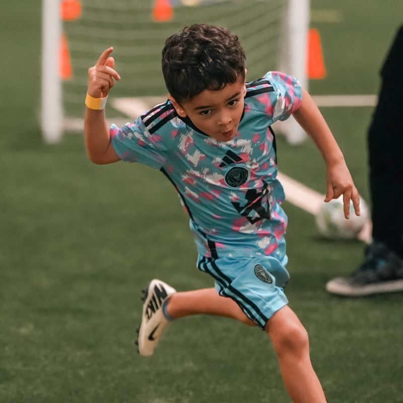 A young boy celebrating a goal at LaLiga Academy Dubai in Dubai Sports City