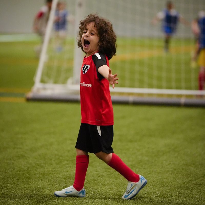 A young boy celebrating at LaLiga Academy Dubai in Dubai Sports City