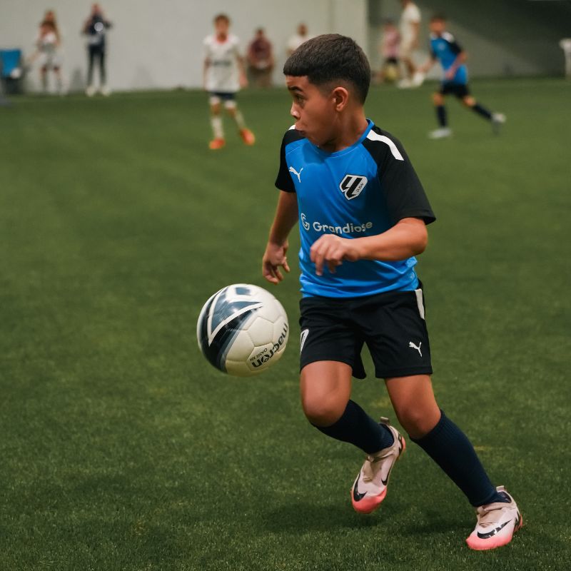 A young boy during a football match at laliga academy uae in ISD Dubai Sports City