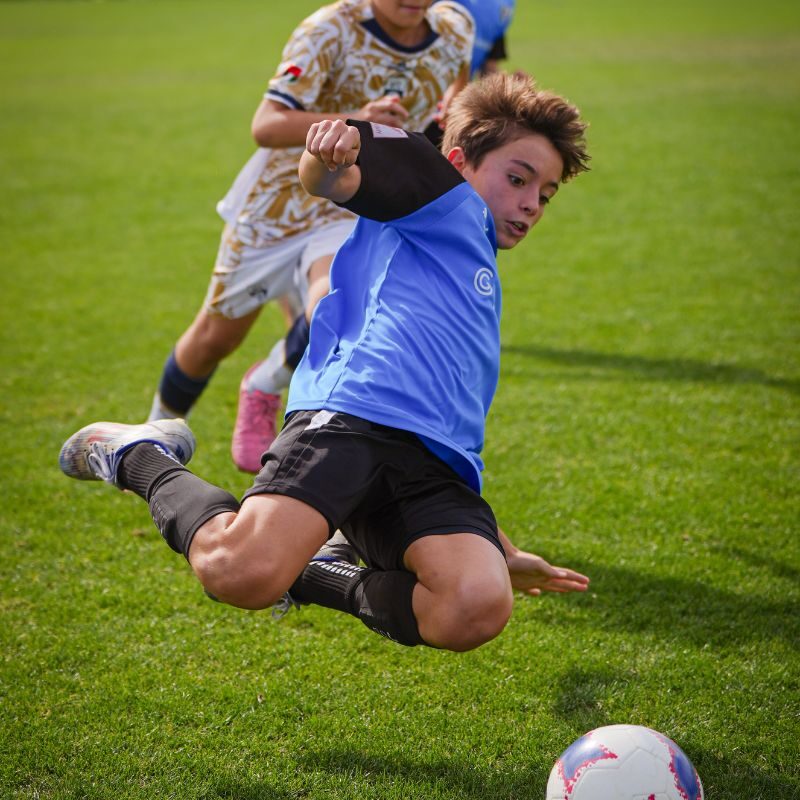 A young football player playing for laliga academy dubai during a match in DOFA league