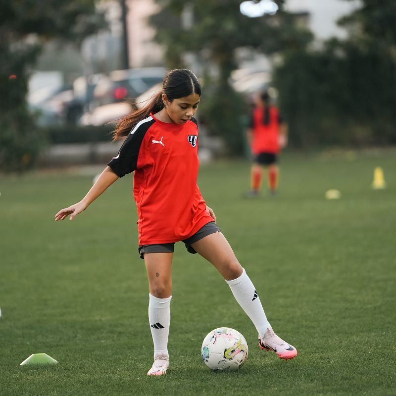 A young girl during a dribling drill at laliga academy uae in Dubai Sports City