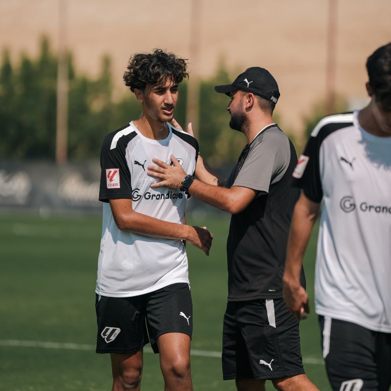 A-football-coach-at-LaLiga-Academy-Dubai-congratulating-a-young-player-after-he-did-well-in his football classes at laliga-academy-dubai sports city