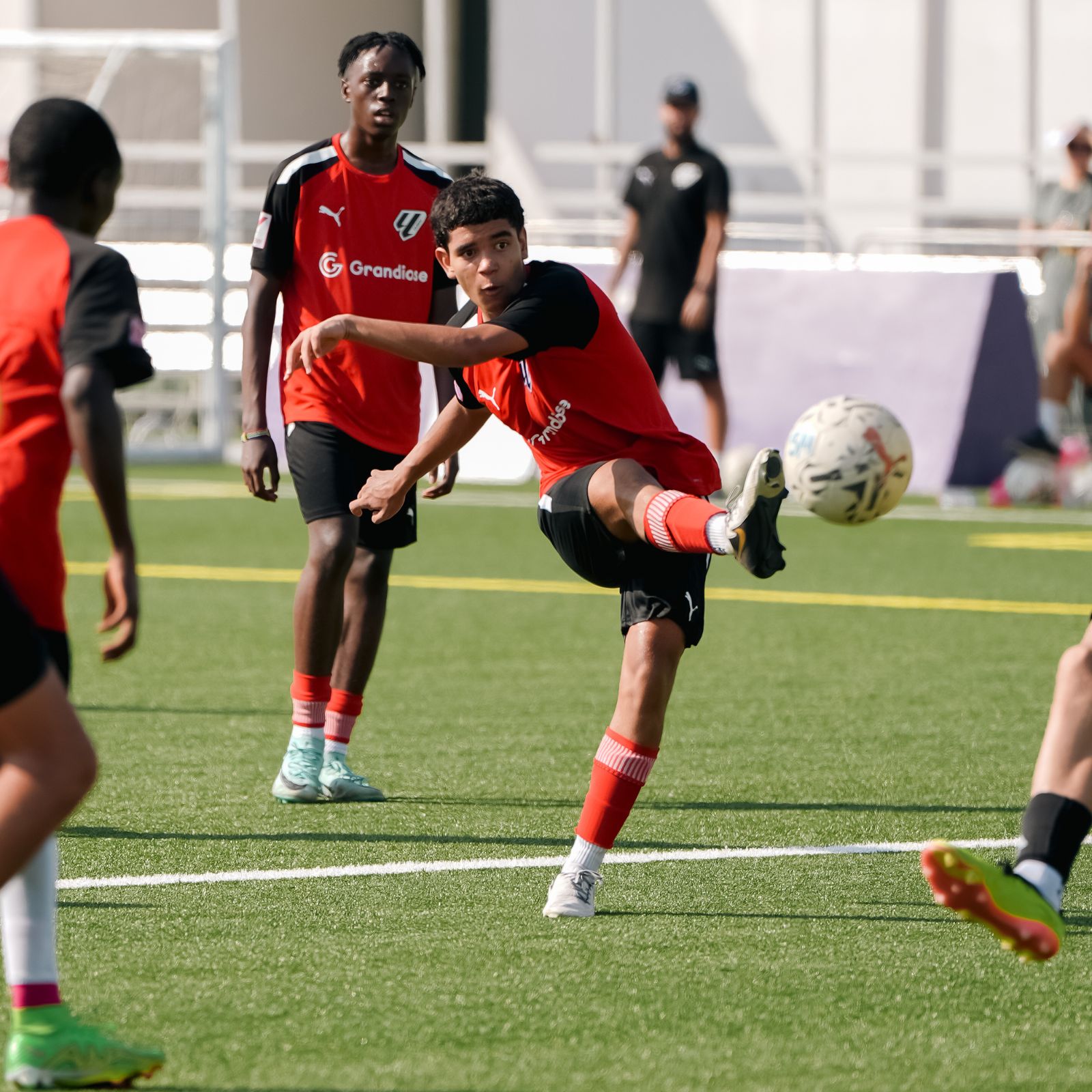 A young boy practising free kicks during his Football coaching classes in dubai sports city at LaLiga Academy Dubai