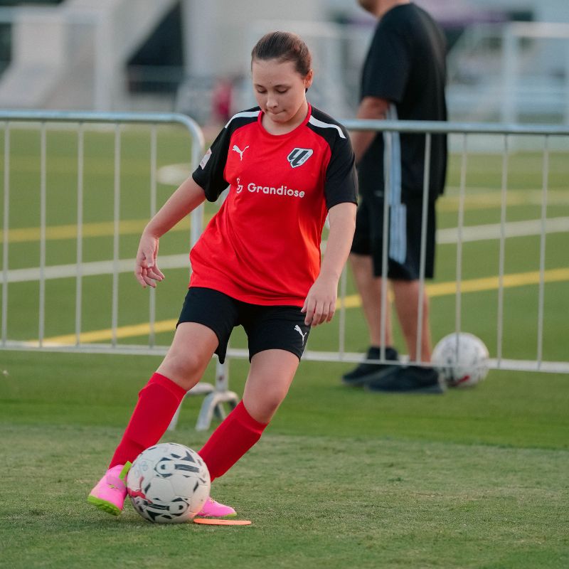 A-young-girl-during-a-drill-at-a-football class near you at laliga-academy-dubai-in-dubai-sports-city